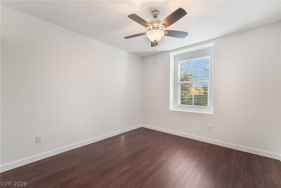 3052 Camino Rico Avenue Henderson, NV 89044 - Photo 34 of 39 Empty room with dark wood-style flooring and a ceiling fan
