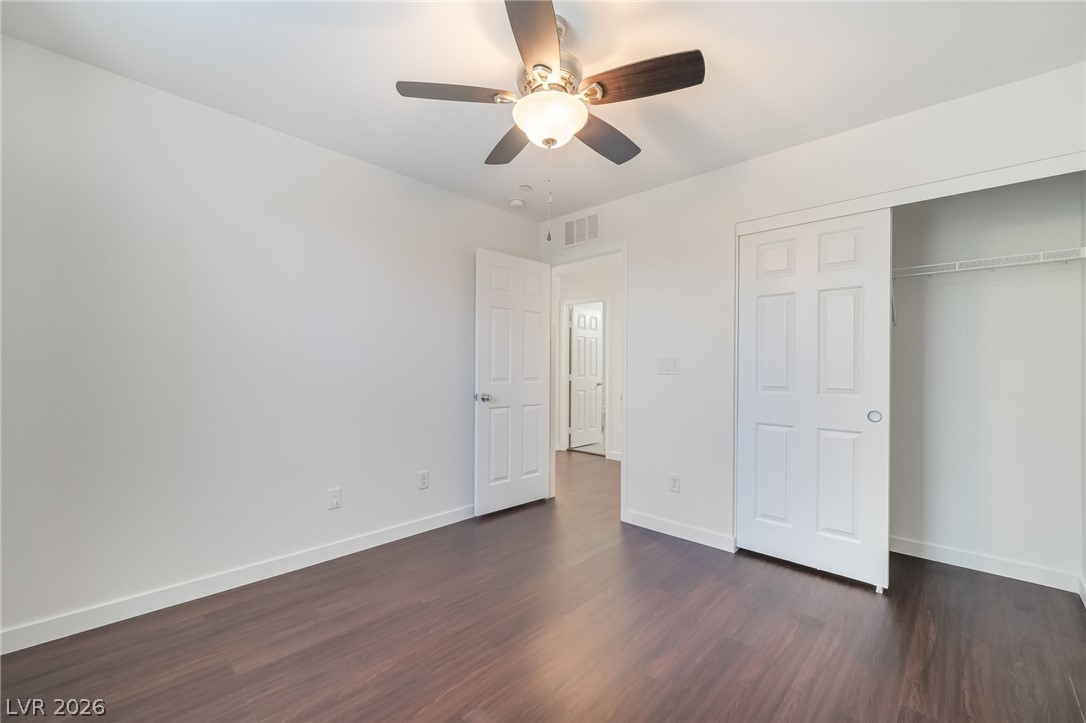 3052 Camino Rico Avenue Henderson, NV 89044 - Photo 35 of 39 Unfurnished bedroom with ceiling fan, dark wood-style floors, and a closet