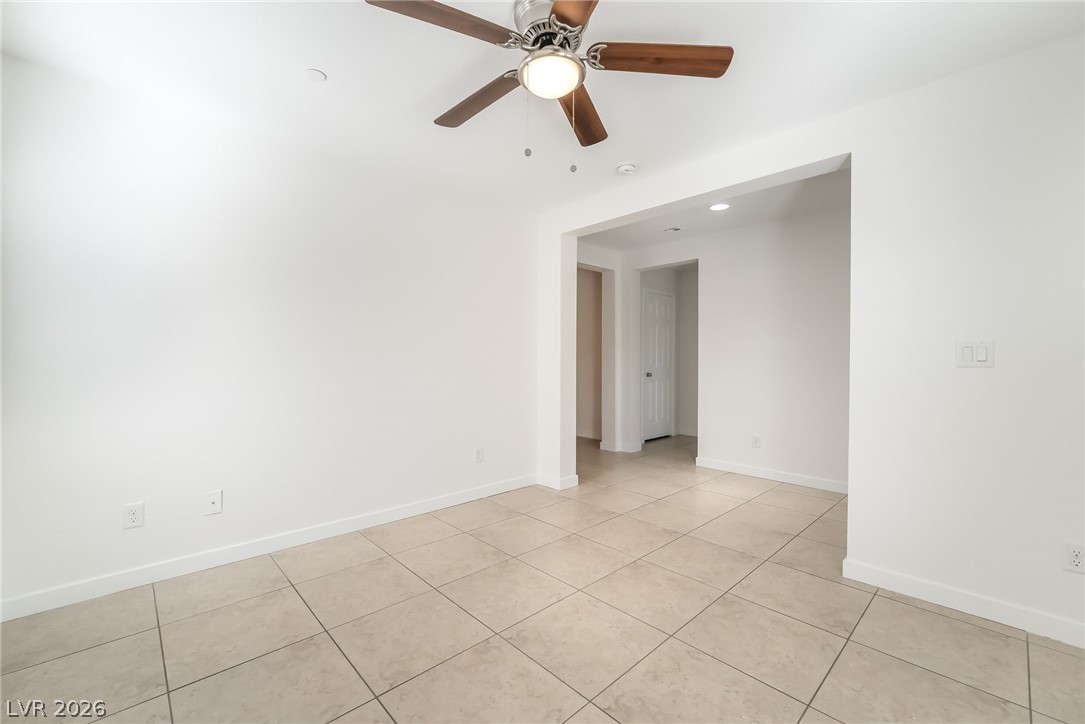 3052 Camino Rico Avenue Henderson, NV 89044 - Photo 7 of 39 Empty room featuring ceiling fan, light tile patterned flooring, and recessed lighting
