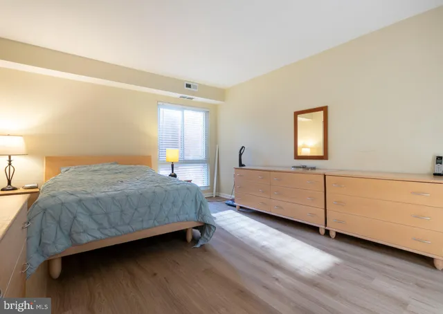 a bedroom with a bed and a night stand