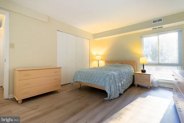 a bedroom with a bed and a dresser