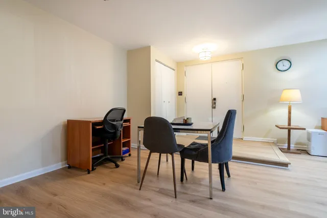 a view of a workspace with furniture and wooden floor