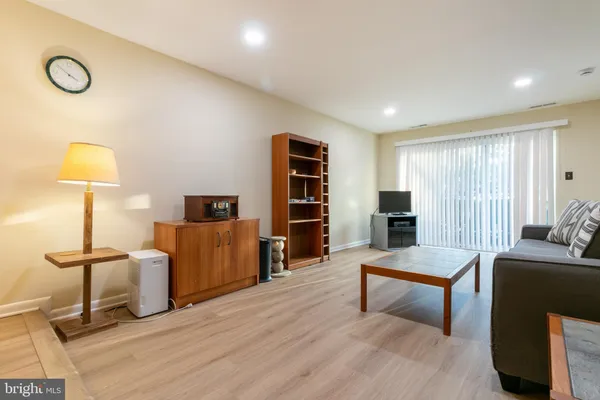 a living room with furniture and a lamp