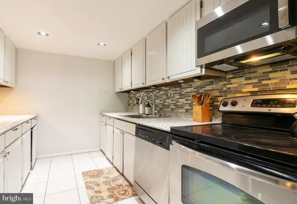 a kitchen with granite countertop a stove and a sink