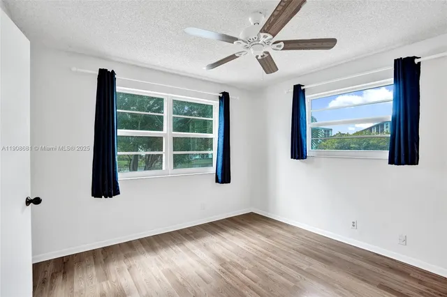 a bathroom with a granite countertop sink mirror and toilet