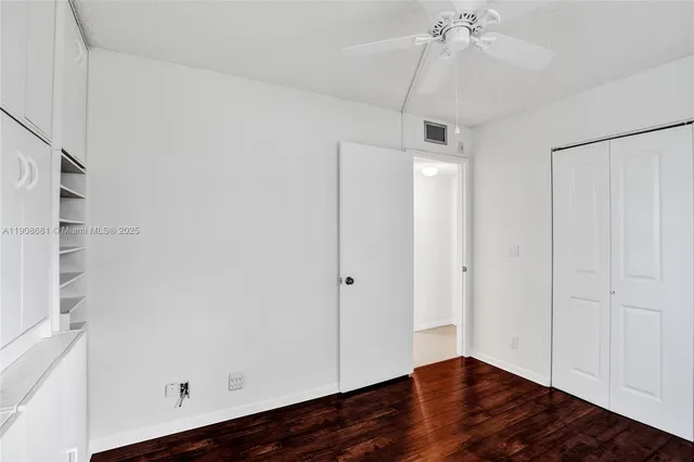 a view of a house with a yard and a large tree