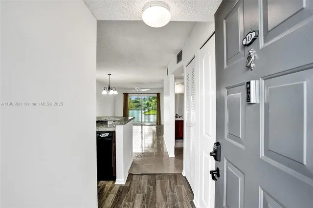 a kitchen with granite countertop a stove sink and cabinets