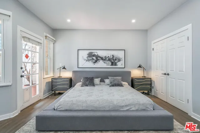 a bedroom with a large bed and a couch