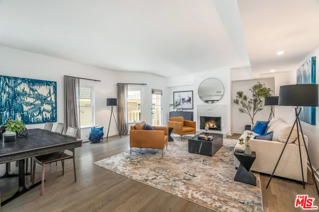 a living room with fireplace furniture and a wooden floor