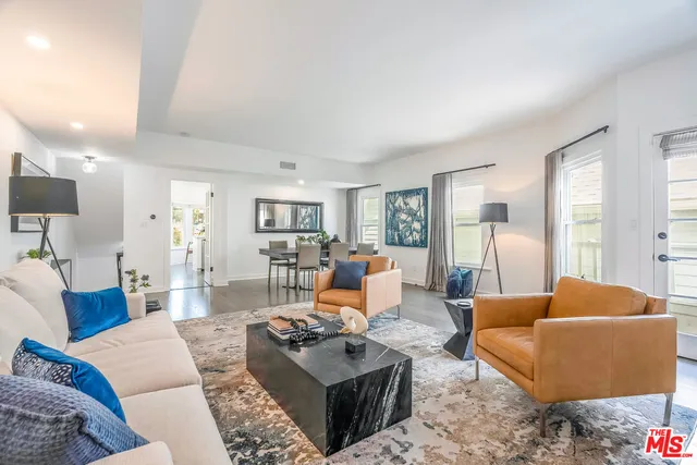 a living room with furniture a rug and a lamp