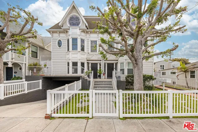 front view of a brick house with large windows