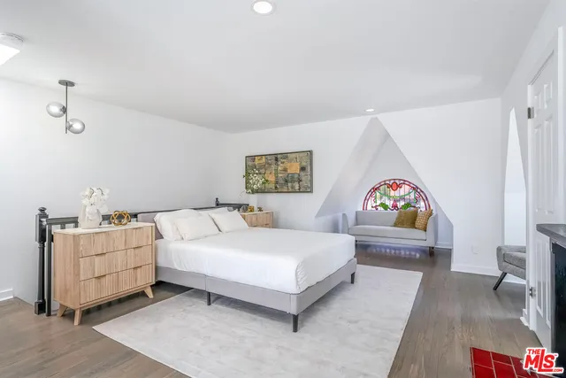 a bedroom with a bed and a desk