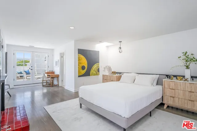 a spacious bedroom with a bed and table