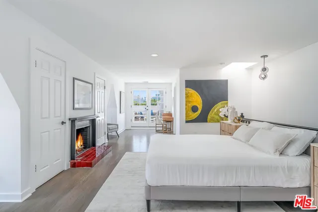 a bedroom with a bed and a fireplace