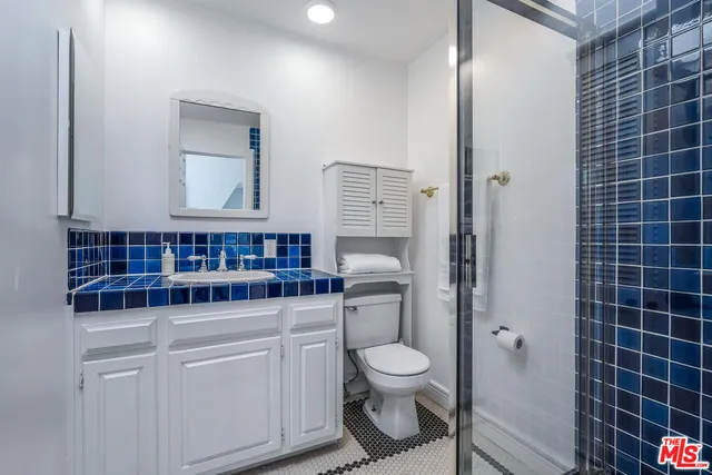 a bathroom with a toilet a sink and shower