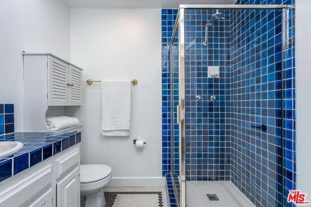 a bathroom with a shower toilet and sink