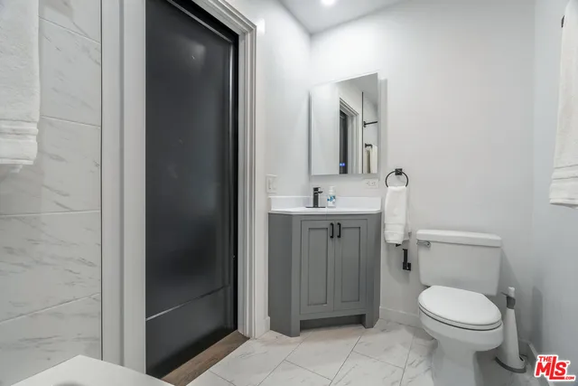 a bathroom with a toilet sink and shower