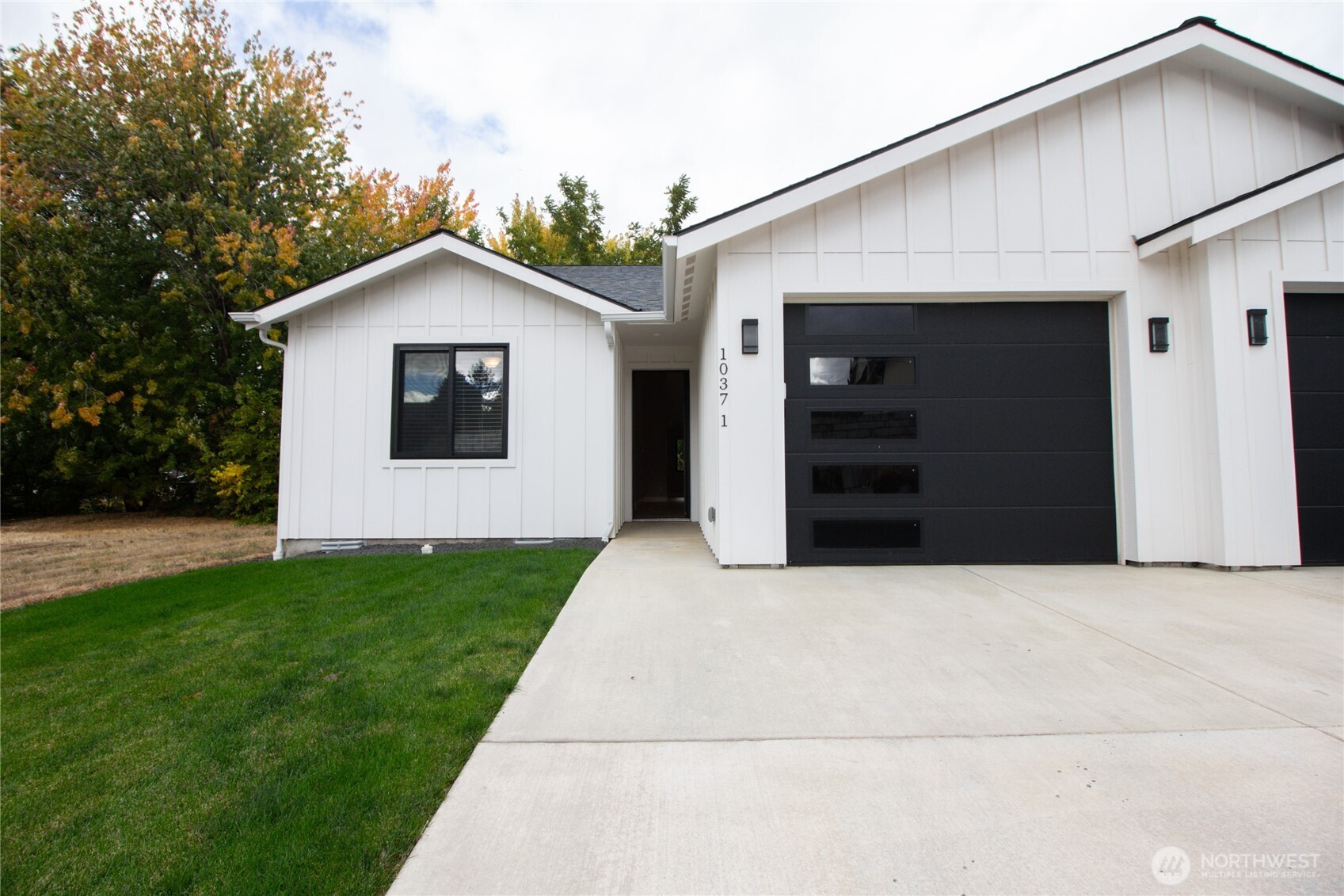 1037 Southeast Date Avenue, Unit 1 College Place, WA 99324 - Photo 2 of 24 a front view of a house with a yard and garage