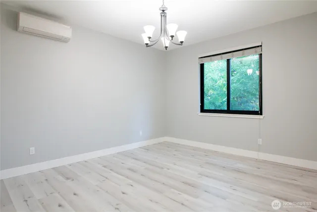 a view of a room with wooden floor and windows
