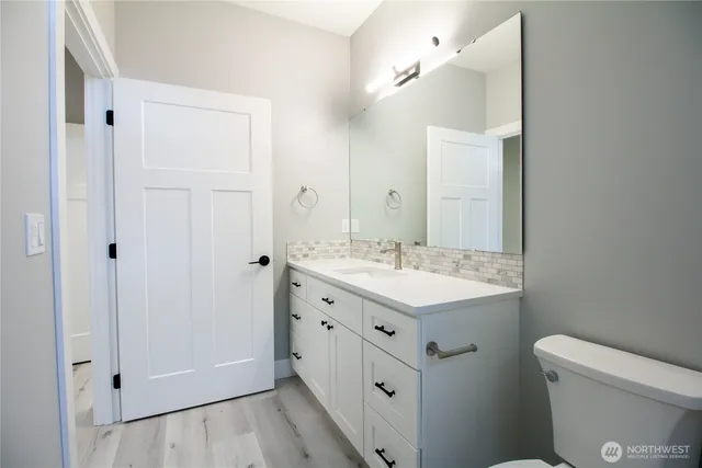 a bathroom with a sink a toilet a shower and a mirror