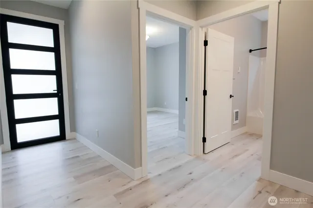 an empty room with wooden floor and window