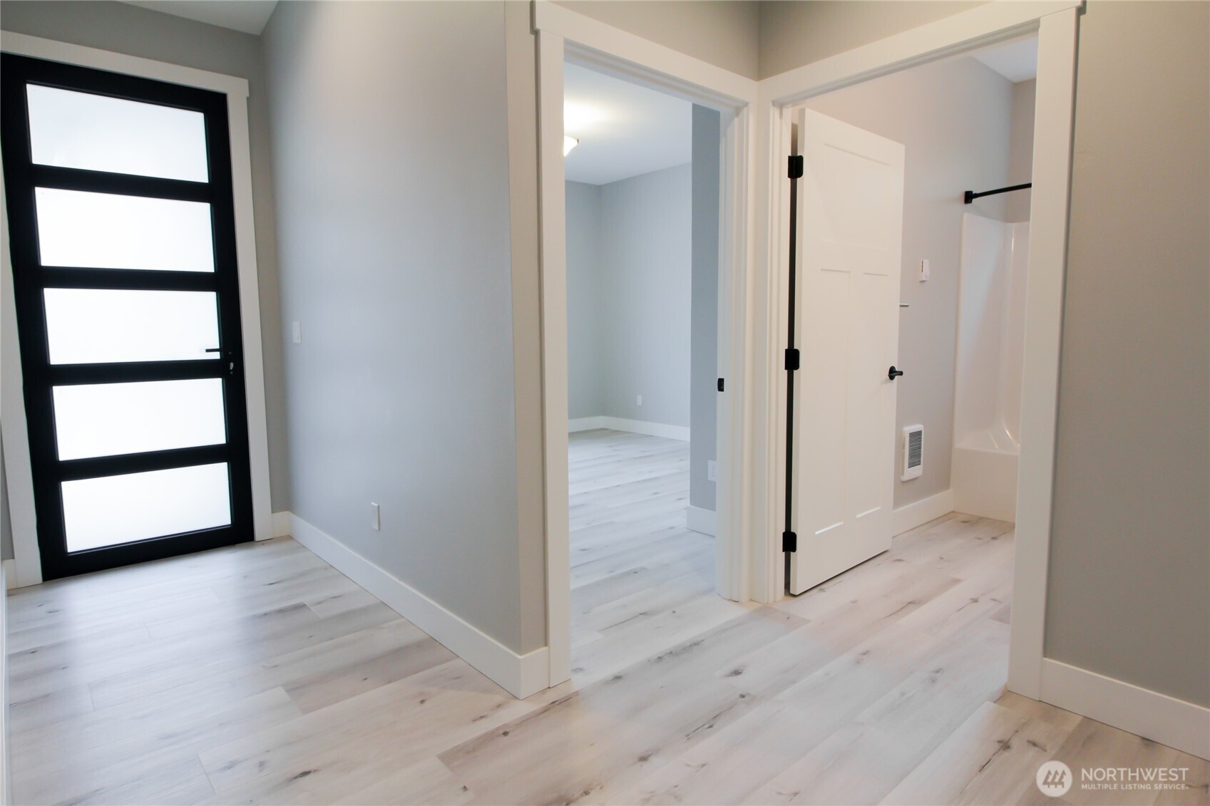 1037 Southeast Date Avenue, Unit 1 College Place, WA 99324 - Photo 5 of 24 an empty room with wooden floor and window