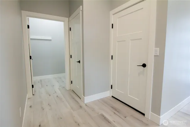 a view of a hallway with wooden floor