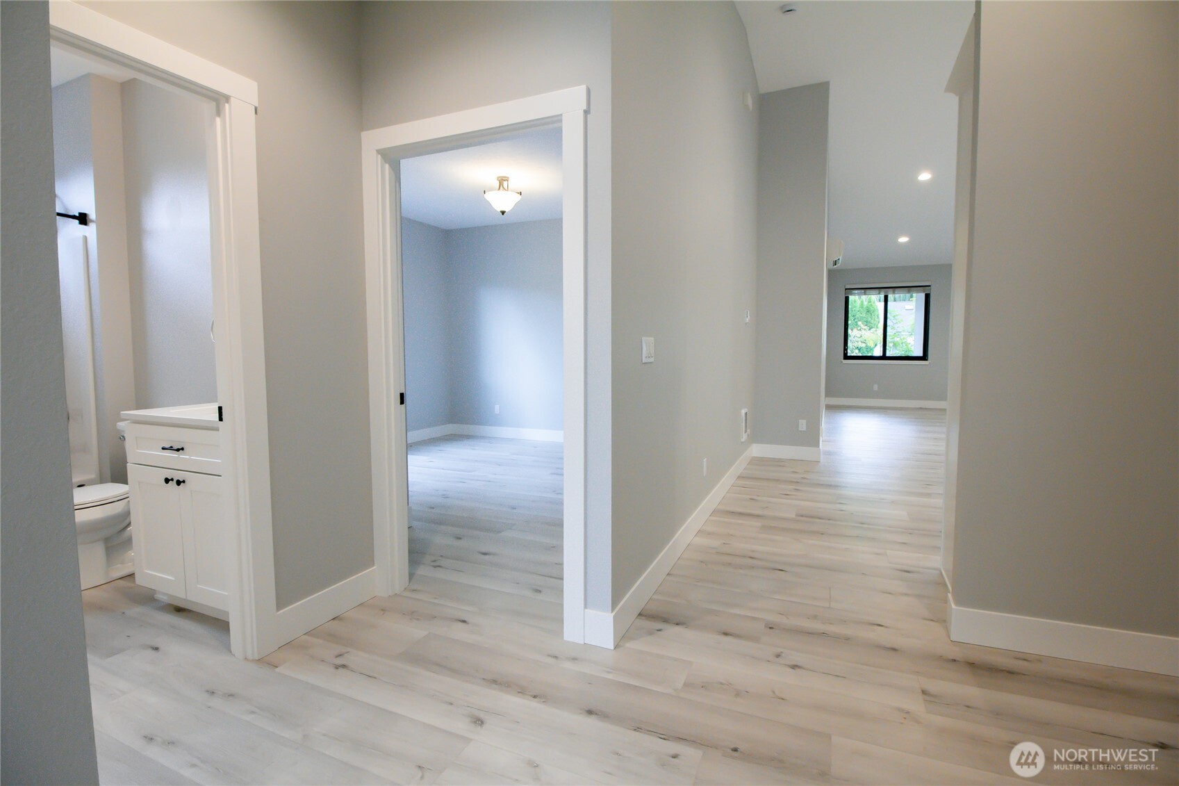 1037 Southeast Date Avenue, Unit 1 College Place, WA 99324 - Photo 9 of 24 wooden floor with a bathroom and mirror