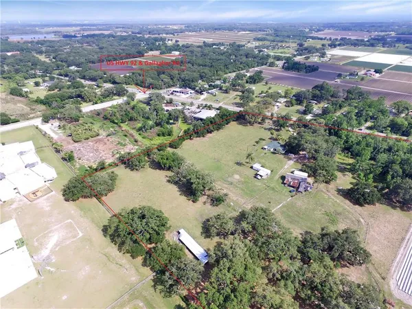 an aerial view of a house with a lake view