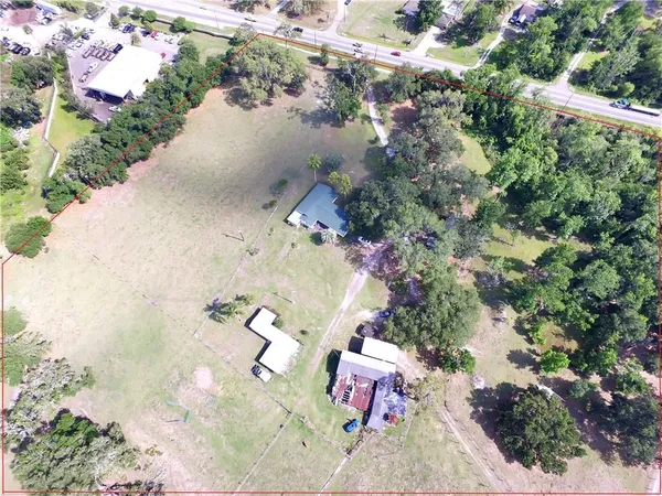 an aerial view of a house with a yard