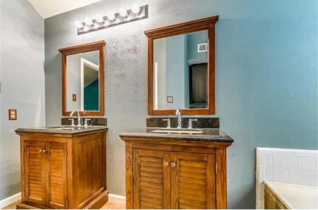 a bathroom with a sink a mirror and vanity