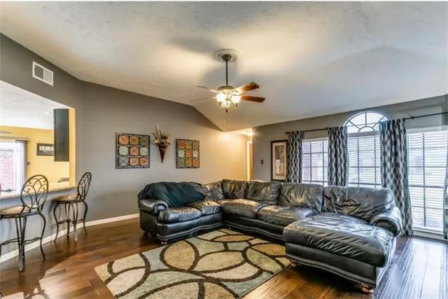 a living room with furniture and a large window