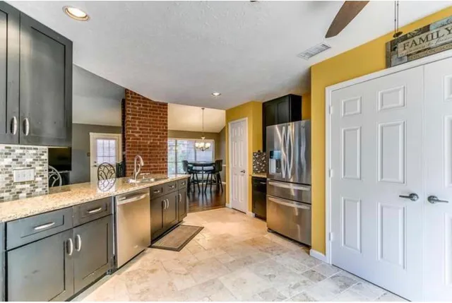 a kitchen with stainless steel appliances a refrigerator and a sink