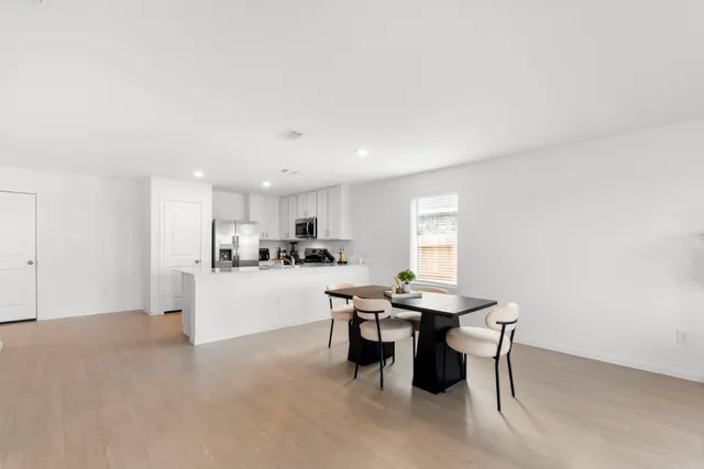 a kitchen with stainless steel appliances kitchen island granite countertop a sink and cabinets
