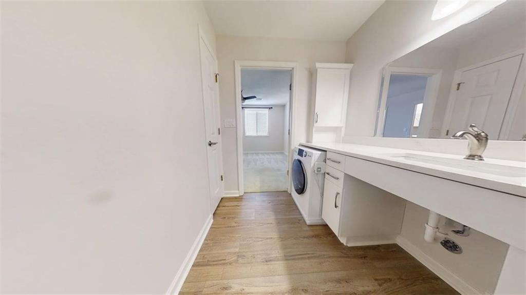 300 Johnson Ferry Road, Unit B805 Sandy Springs, GA 30328 - Photo 27 of 31 a spacious bathroom with a double vanity sink and mirror