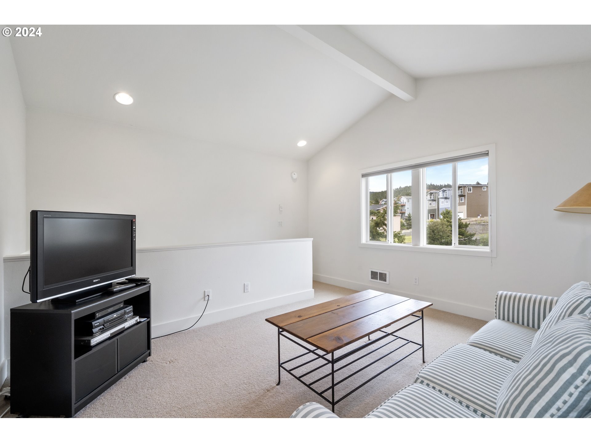 250 Capes Drive Oceanside, OR 97141 - Photo 15 of 38 a living room with furniture and a flat screen tv