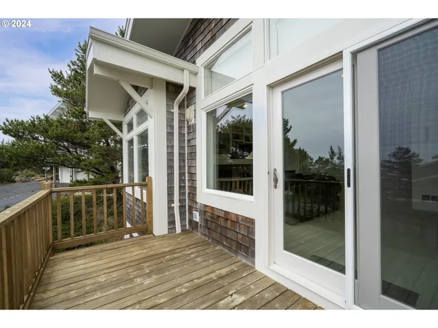 a view of a balcony with wooden floor