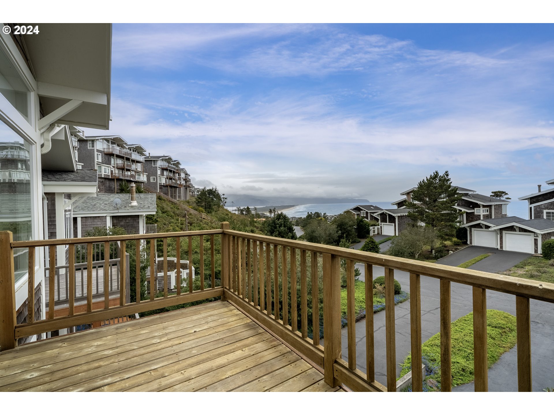 250 Capes Drive Oceanside, OR 97141 - Photo 18 of 38 a view of a balcony with wooden floor