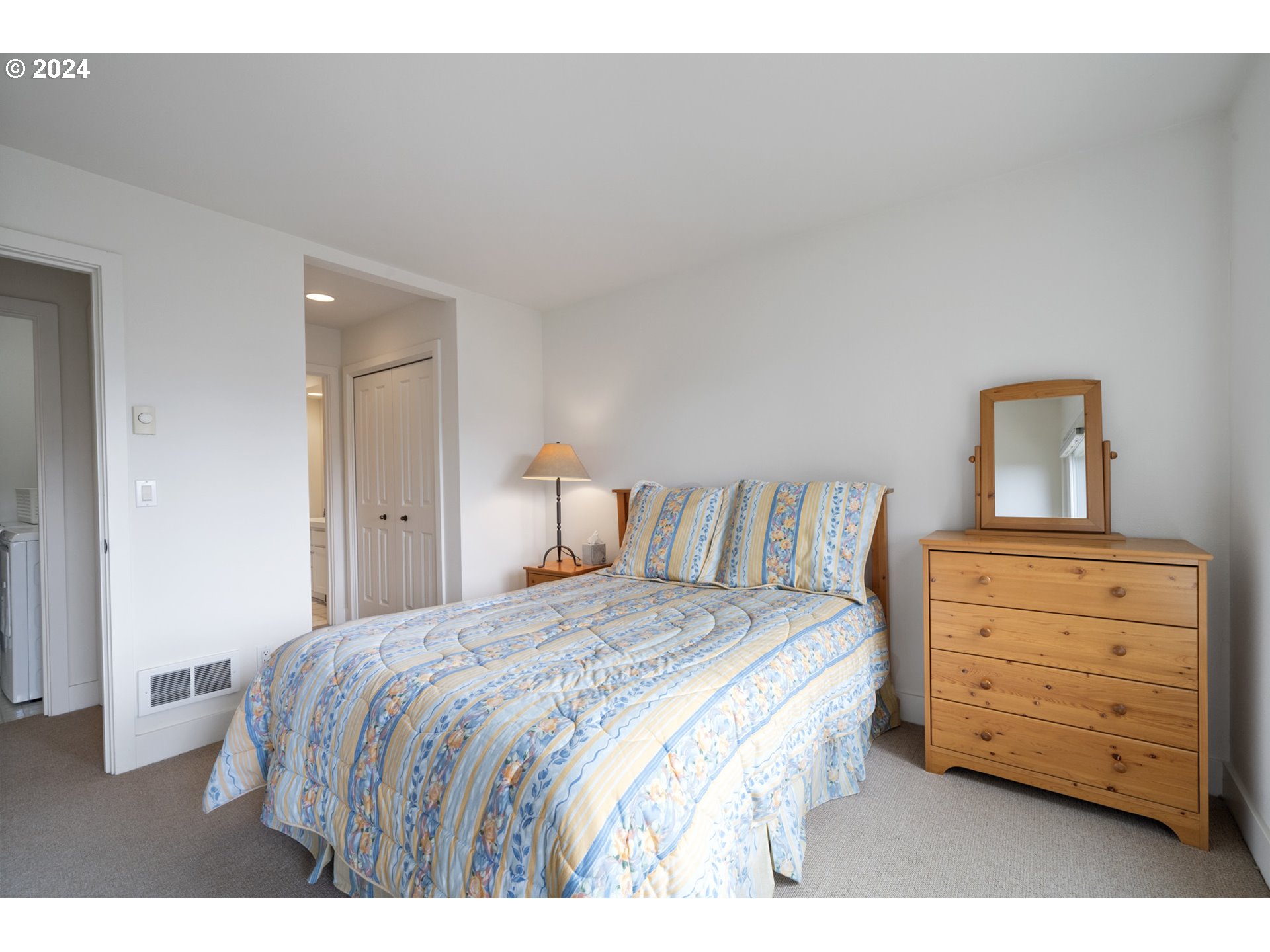 250 Capes Drive Oceanside, OR 97141 - Photo 21 of 38 a bedroom with a bed and a dresser