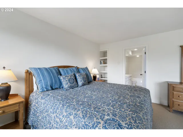 a bedroom with a bed and cabinet