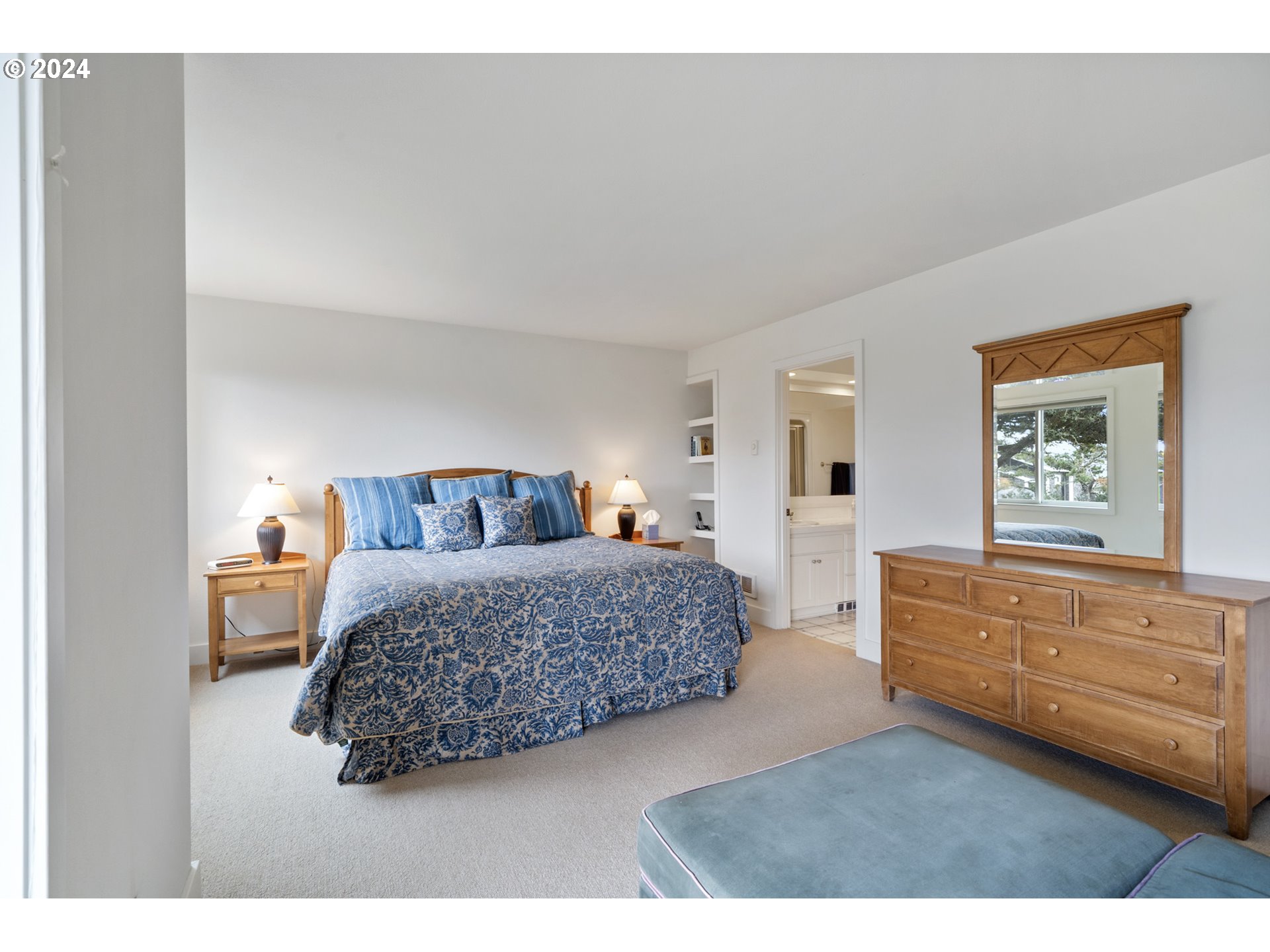 250 Capes Drive Oceanside, OR 97141 - Photo 26 of 38 a bedroom with a bed and cabinet