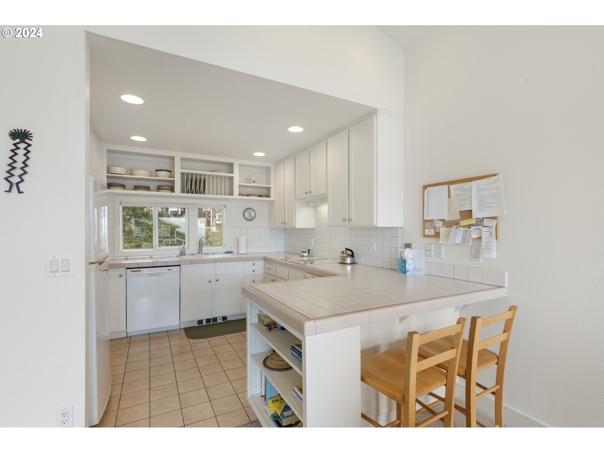 250 Capes Drive Oceanside, OR 97141 - Photo 9 of 38 a kitchen with a sink a stove a dining table and chairs