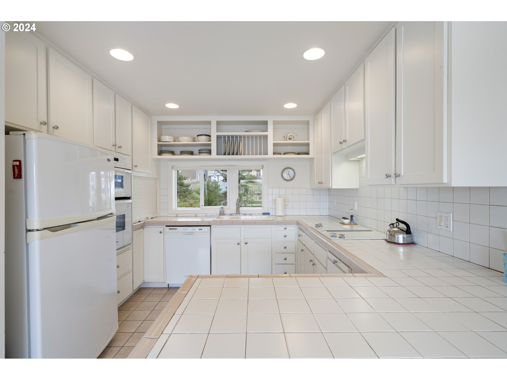 250 Capes Drive Oceanside, OR 97141 - Photo 10 of 38 a kitchen with a refrigerator a sink and cabinets