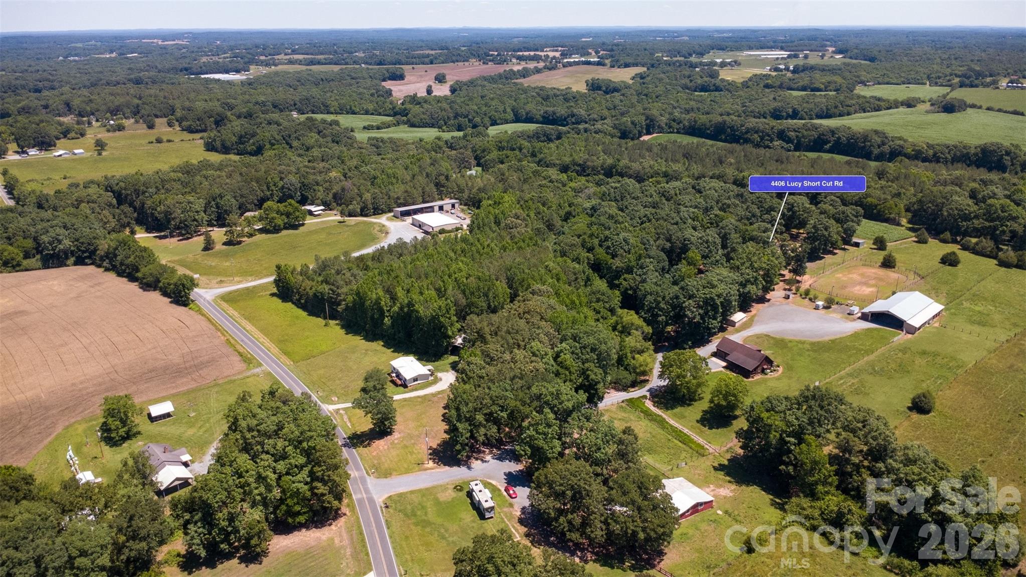 4406 Lucy Short Cut Road Marshville, NC 28103 - Photo 28 of 30 an aerial view of residential houses with outdoor space and trees