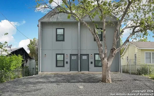 a view of a house with a tree