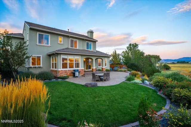 a front view of a house with swimming pool having outdoor seating
