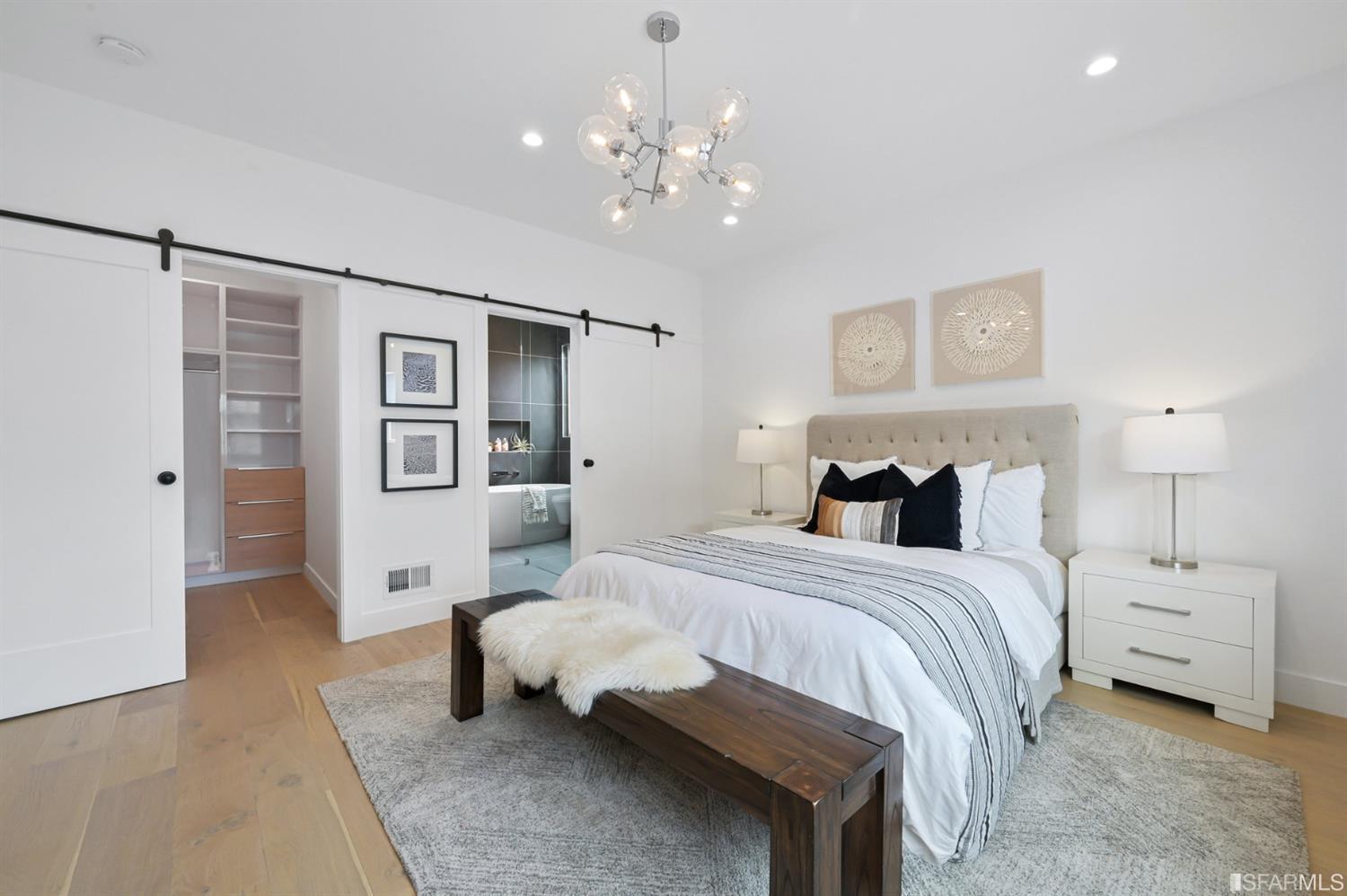 464 Lansdale Avenue San Francisco, CA 94127 - Photo 29 of 61 a spacious bedroom with a bed and a chandelier