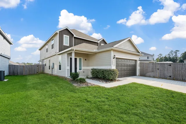 a view of a house with a yard and pathway