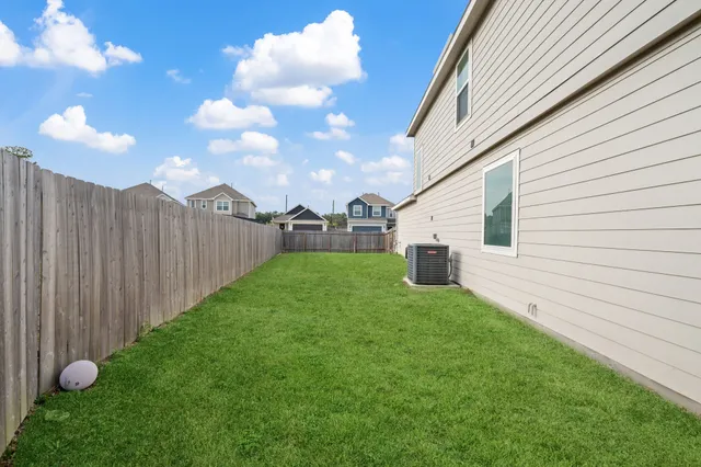 a view of a backyard with grass and entertaining space
