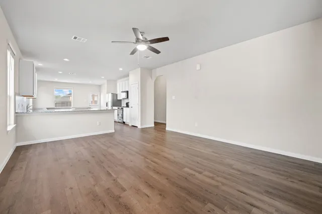 a view of a kitchen with a sink and wooden floor